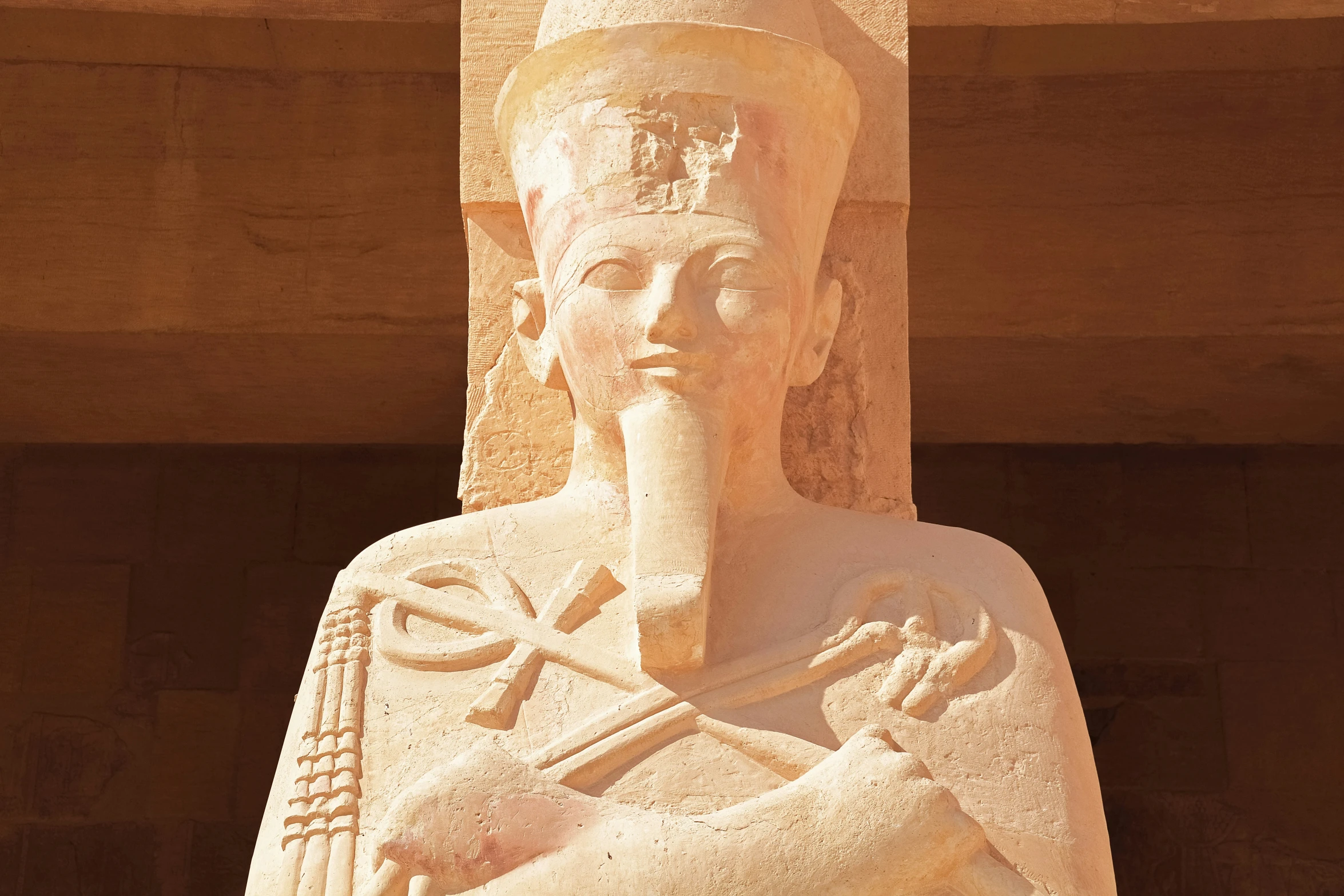 an egyptian statue of a man holding an infant