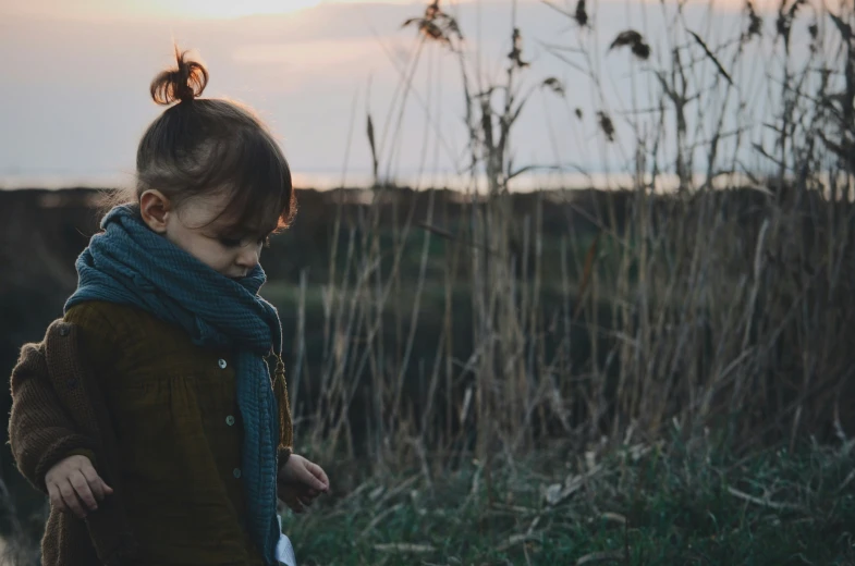 a little girl that is standing in a field