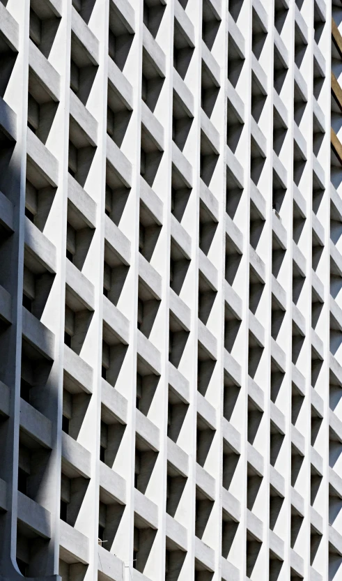 an abstract concrete structure with windows and a parking meter