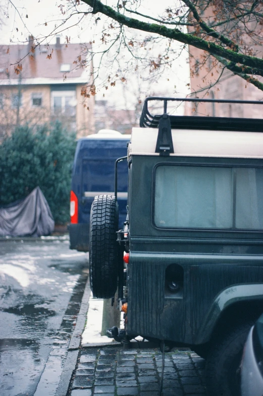 a back end view of a small car with trailer attached on it