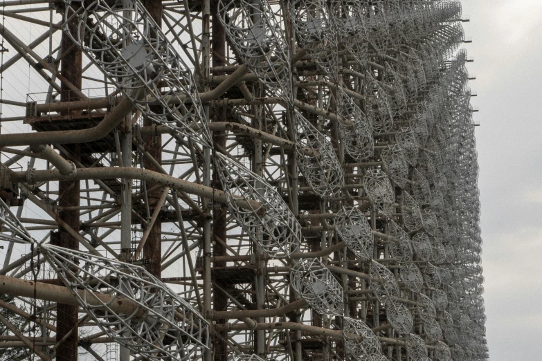 some metal scaffolding and pipes in the middle of the day