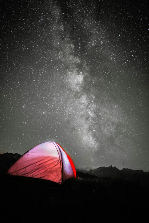 a large tent is set up under the stars