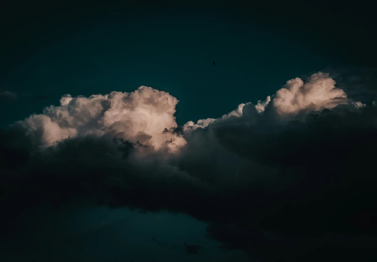 some clouds are lit up by an approaching storm