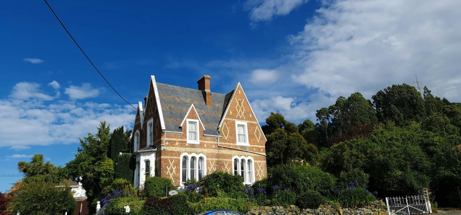 a brick building surrounded by many trees