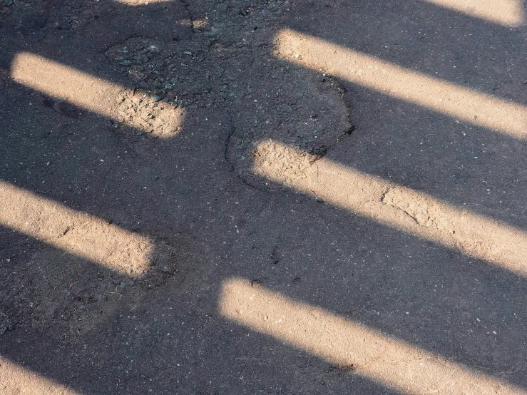 a white fire hydrant and a curb on asphalt