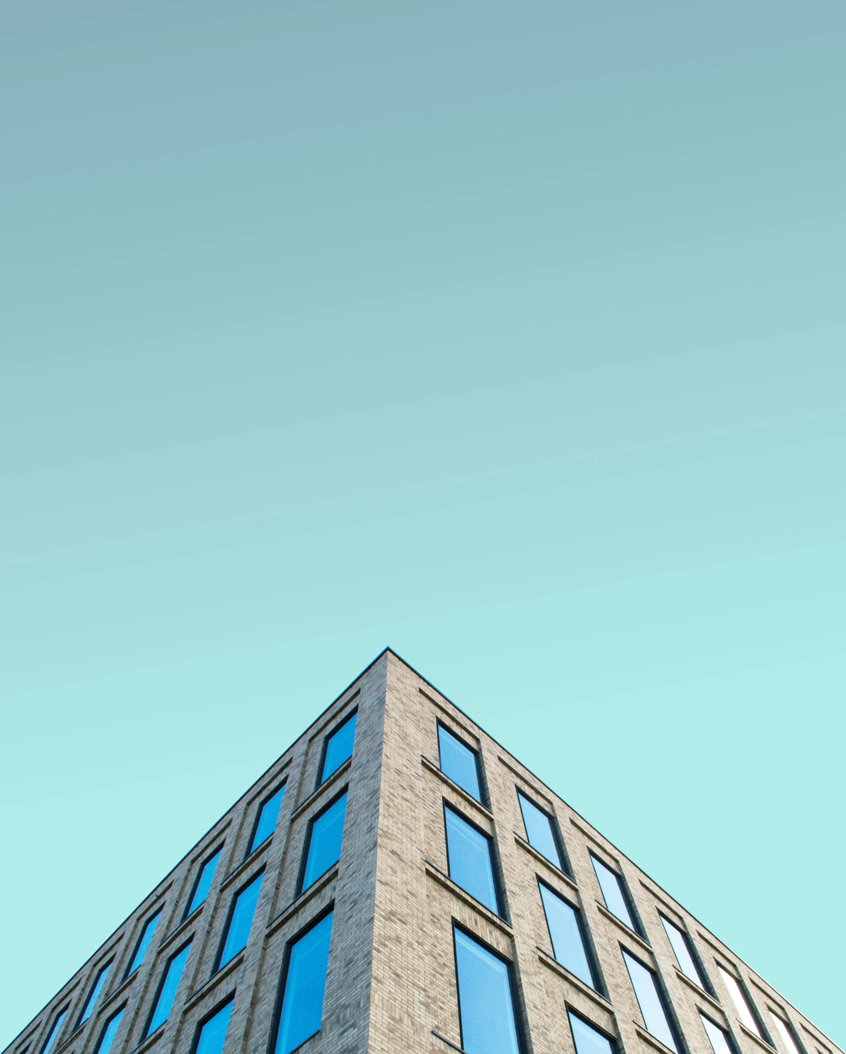 a blue building with three stories on the top of it