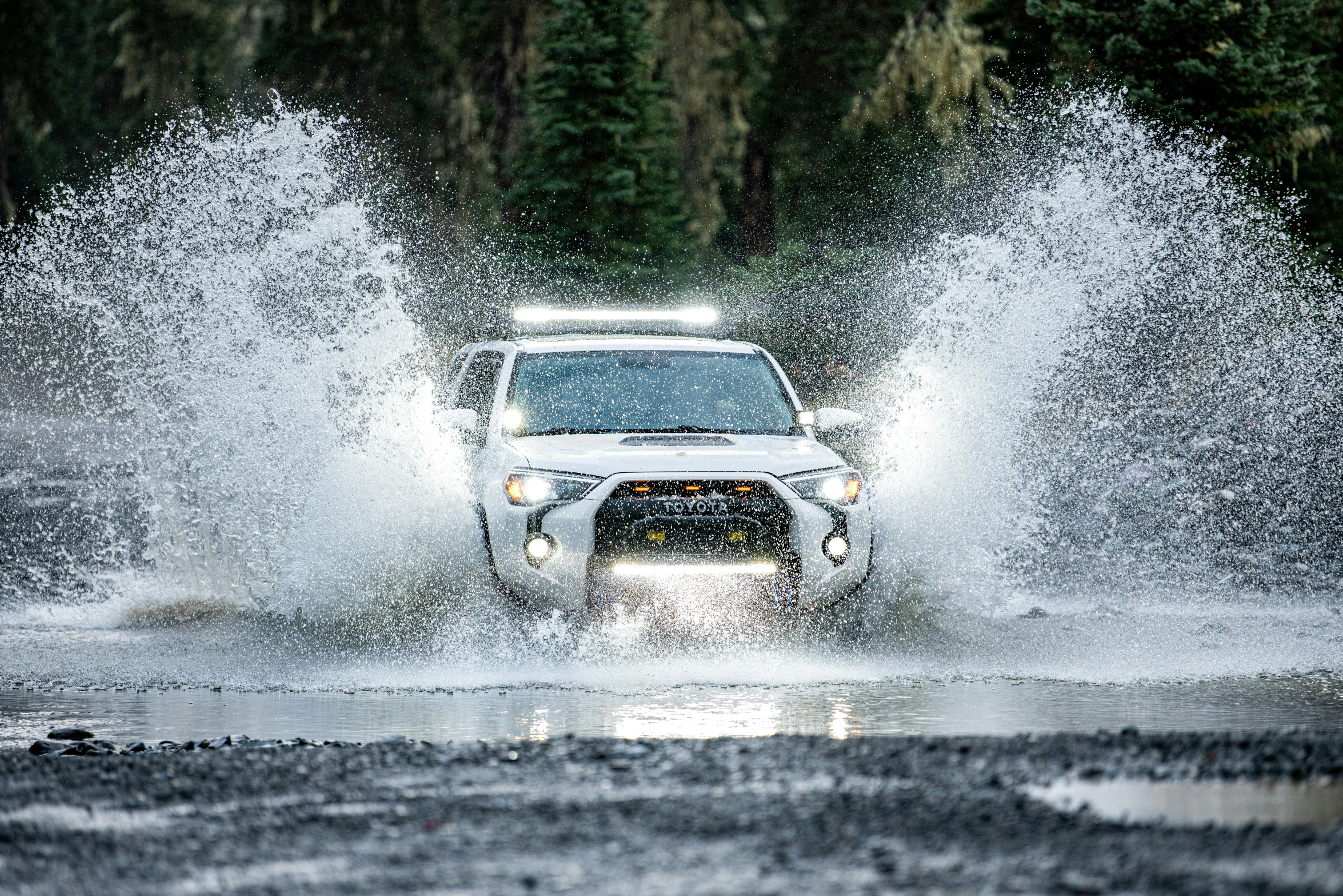 the vehicle is driving through the deep water