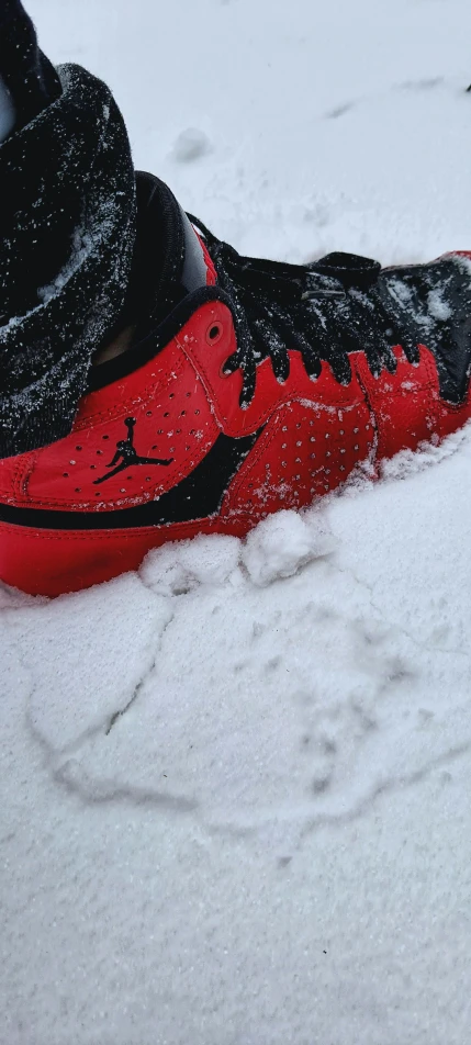 there is snow falling off the top of a sneaker