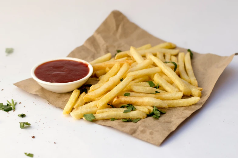 some french fries are sitting on the napkin