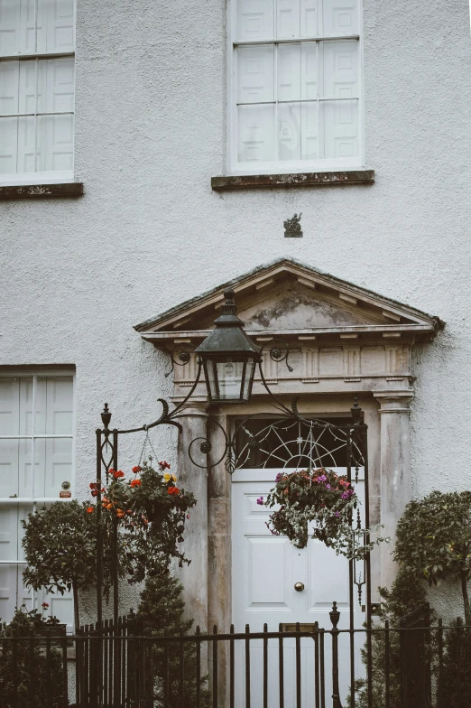 a house with an iron gate and flower pots