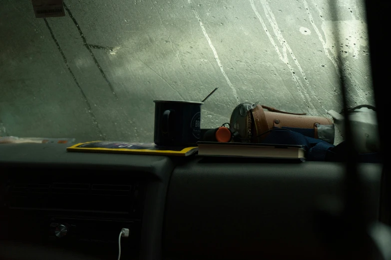 an image of a mug and books in a car