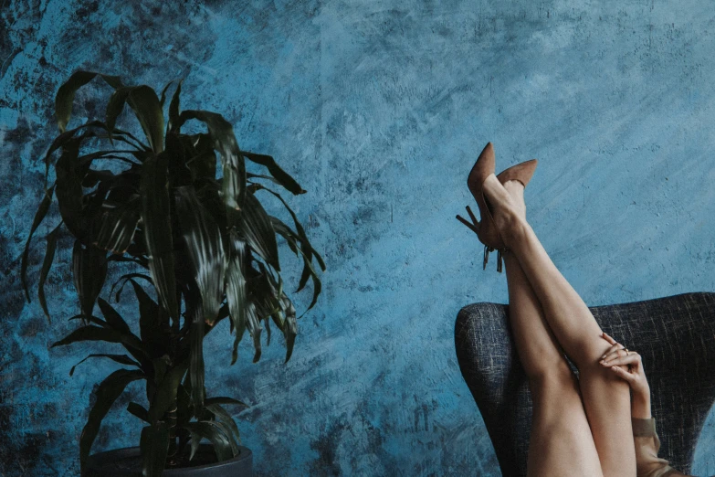 woman with bare feet relaxing in an armchair