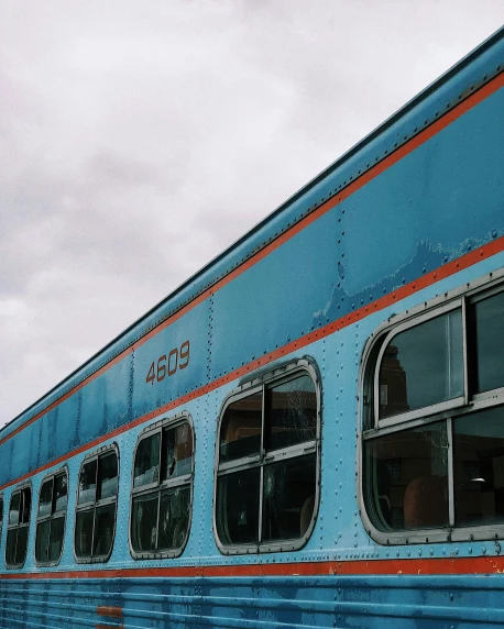 a close up of a blue train with windows on the side