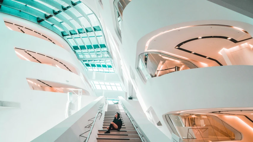 a long stairway going up to a building with a skylight