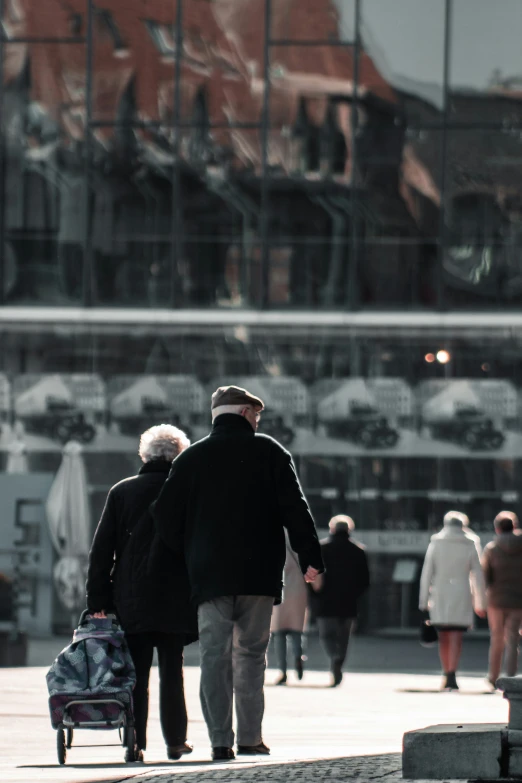 an older couple are walking with their suitcases