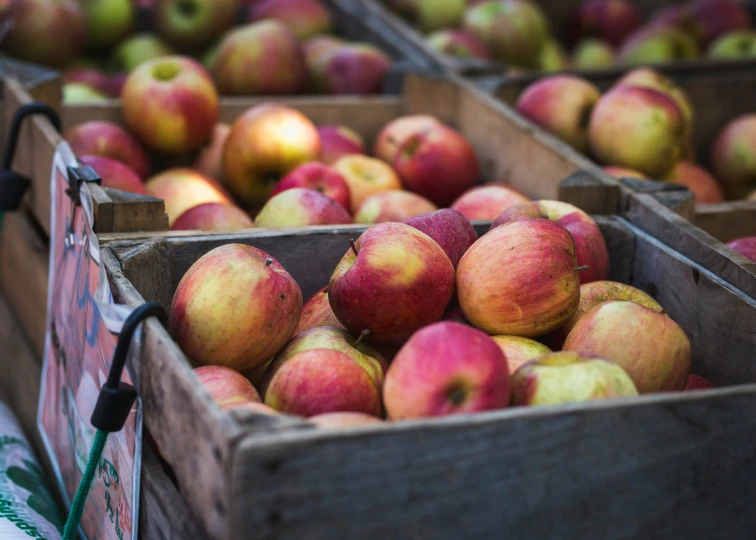 apples that are sitting inside of wooden boxes