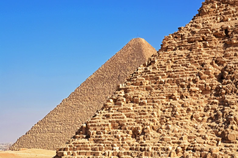 a pyramid with large brick walls stands in the desert