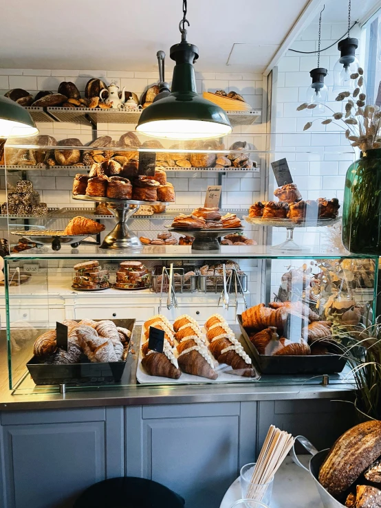 a display of pastries is displayed on shelves at a bakery