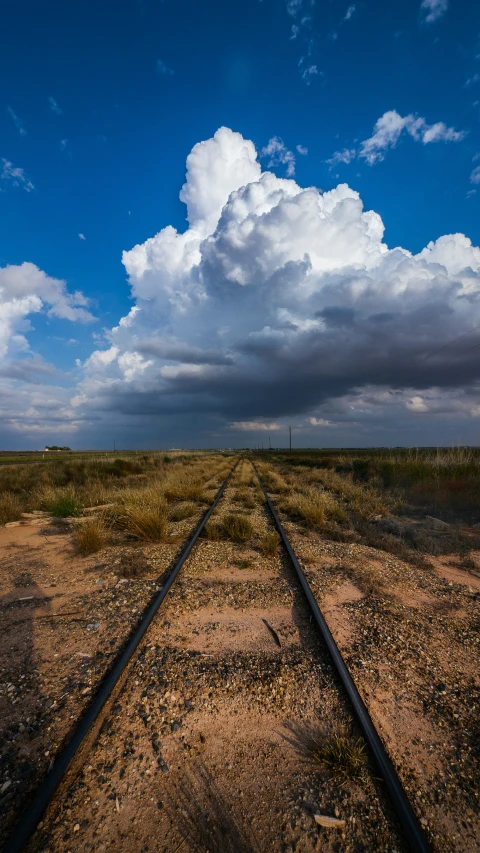 a lone train track stretches into the distance