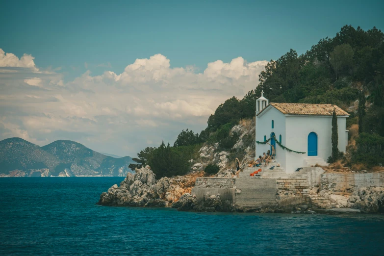 an island with a small church next to a body of water