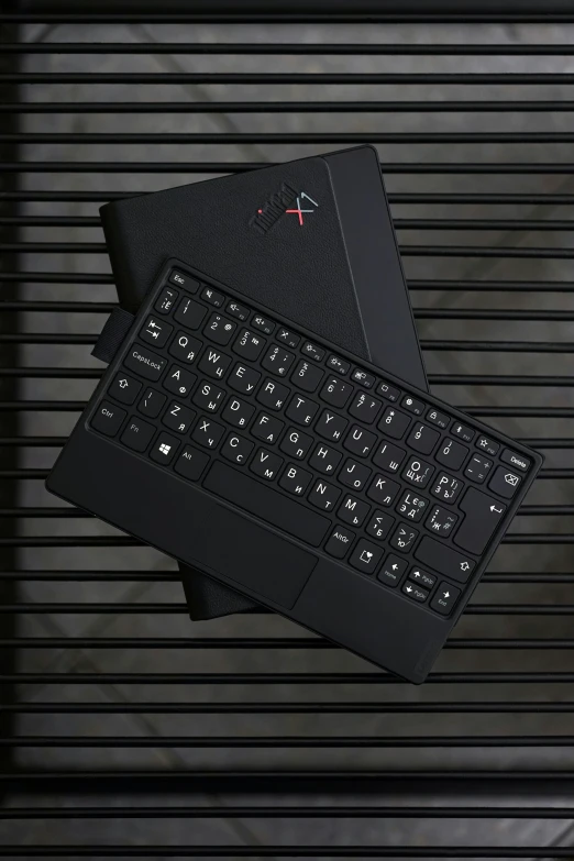 a keyboard next to a tablet is seen in this image