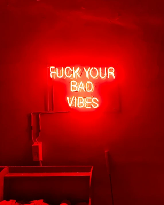 a red neon sign in the middle of a room