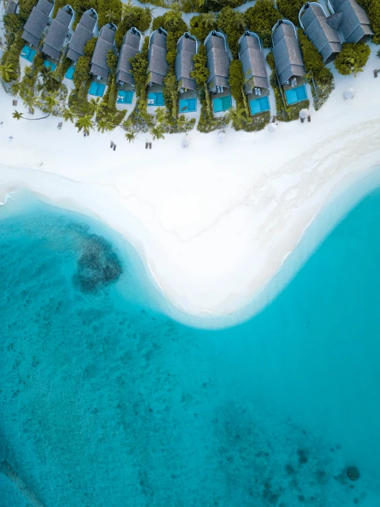 an aerial view of a resort over the ocean