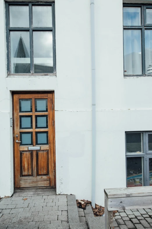 there is a bench in front of this white building