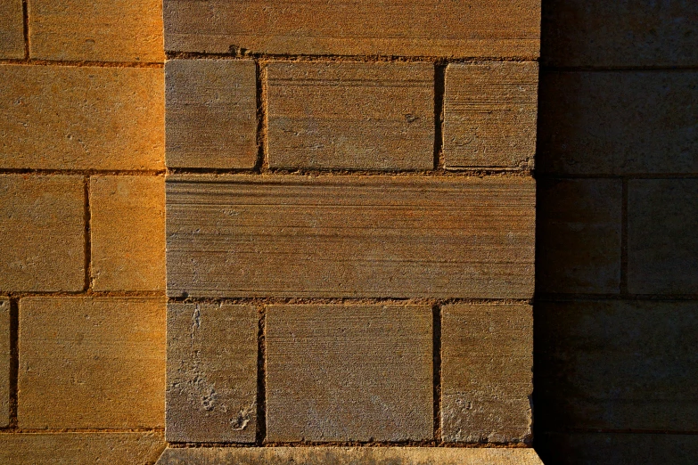 a brick wall in yellow and brown tones