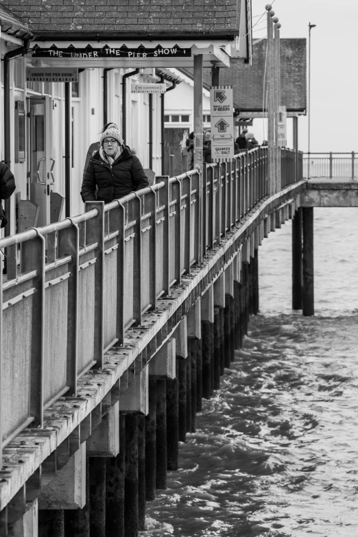 an older man and  standing on the side of a pier