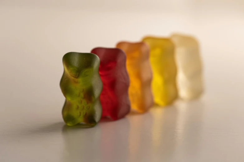 a row of gummy bears on a white counter