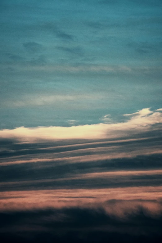 a plane in the sky with some clouds