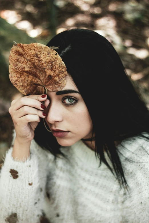 a woman looks through her leaf to see what the plant is called