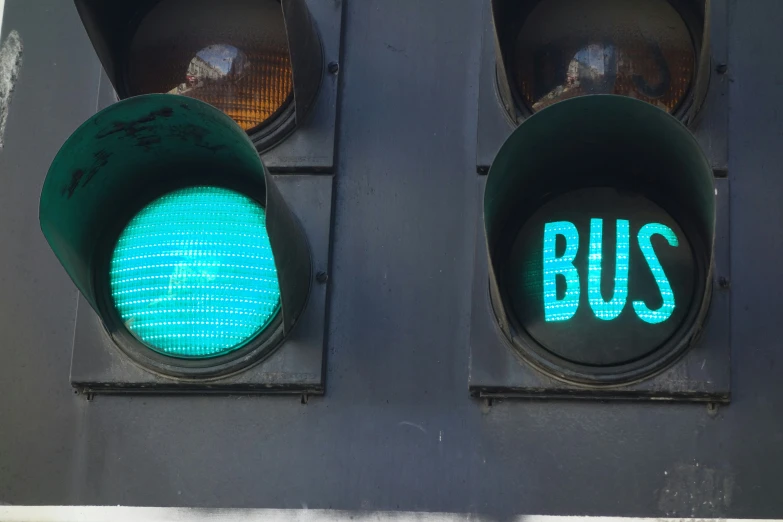 a close up of two green lights with two different colored stoplights