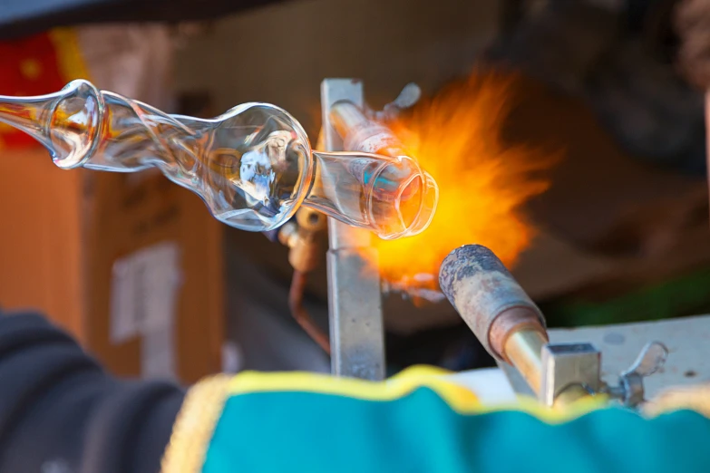 a person pouring a glass tube on a device