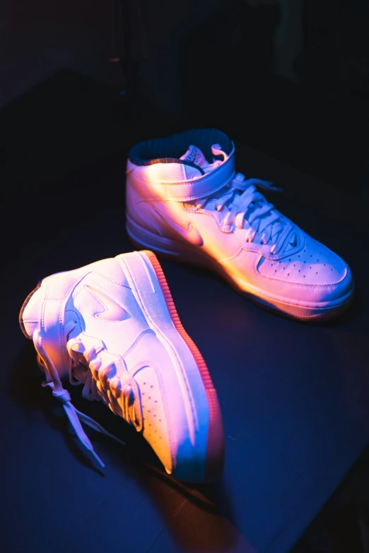 there are two pairs of glowing sneakers on the table