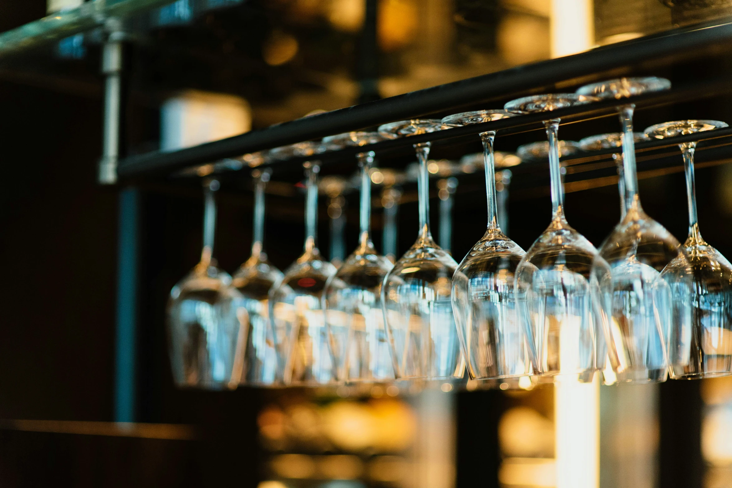 wine glasses are hanging in the glass holder