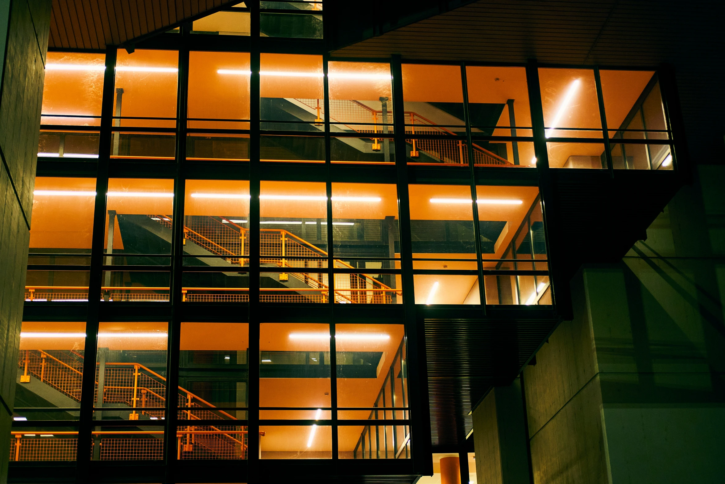 a dark building with an illuminated staircase and staircases