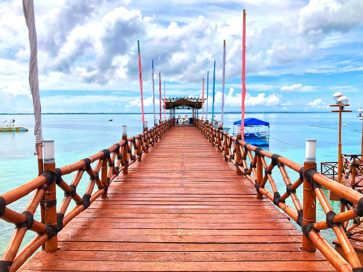 a long pier with a sky background