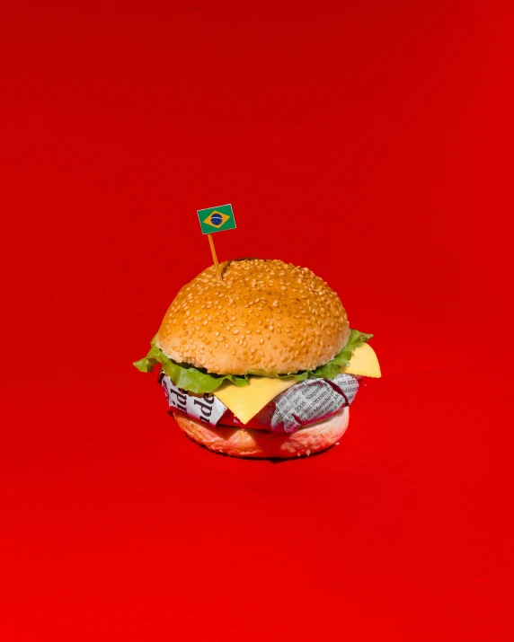 a hamburger on top of a red surface