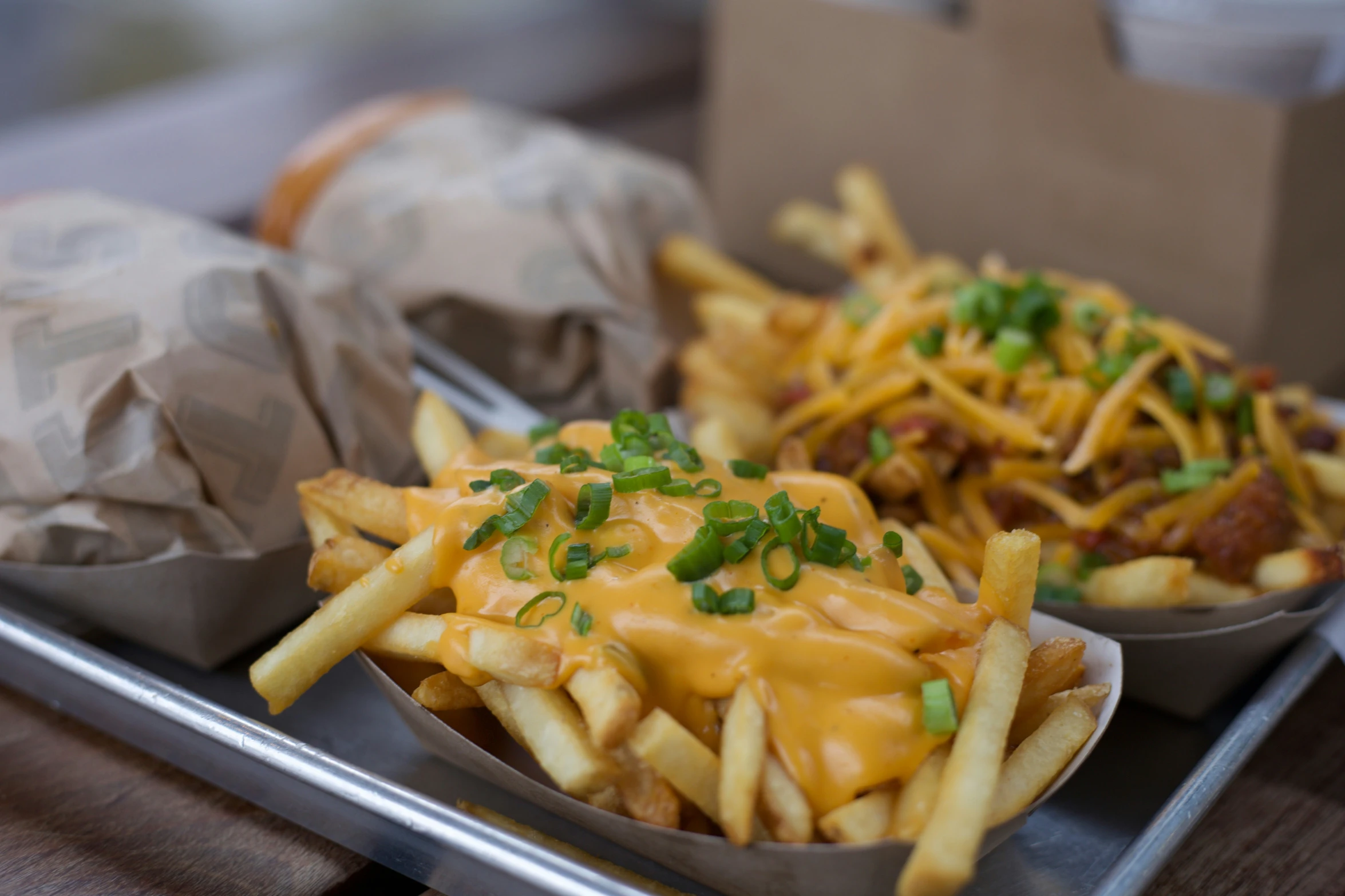 loaded french fries covered in cheese and relish on a plate