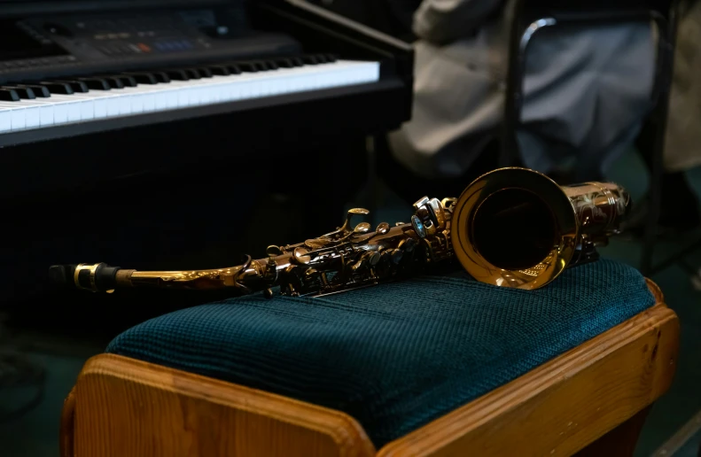 saxophone on a piano with an instrument in the background