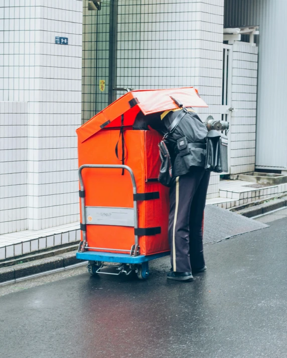 a man is hing a cart with a luggage bag