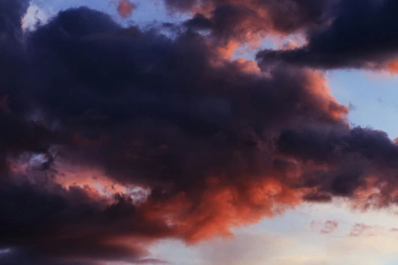 the plane is flying high into the cloudy sky