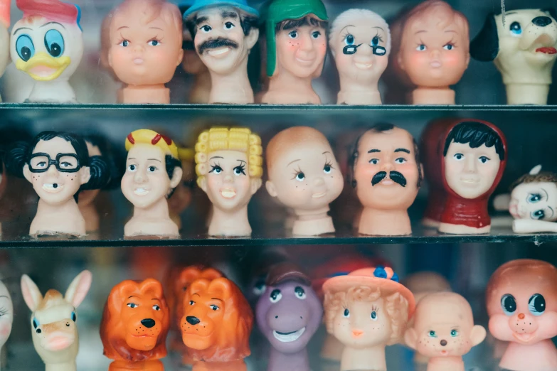 many different colored plastic heads on display