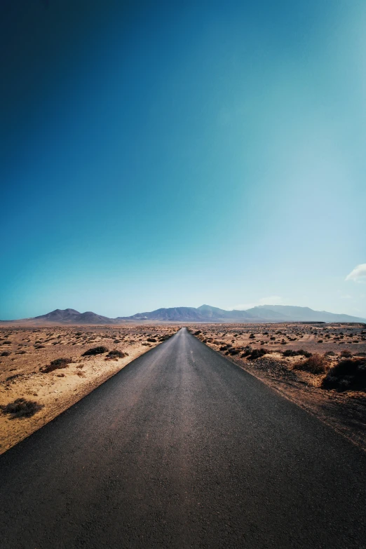 the asphalt road is deserted and empty of cars