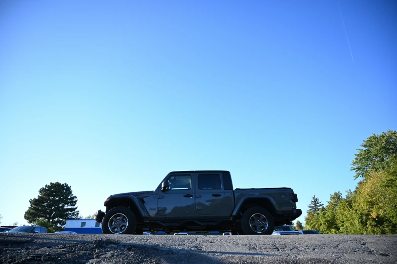 a pickup truck sits parked on the side of the road