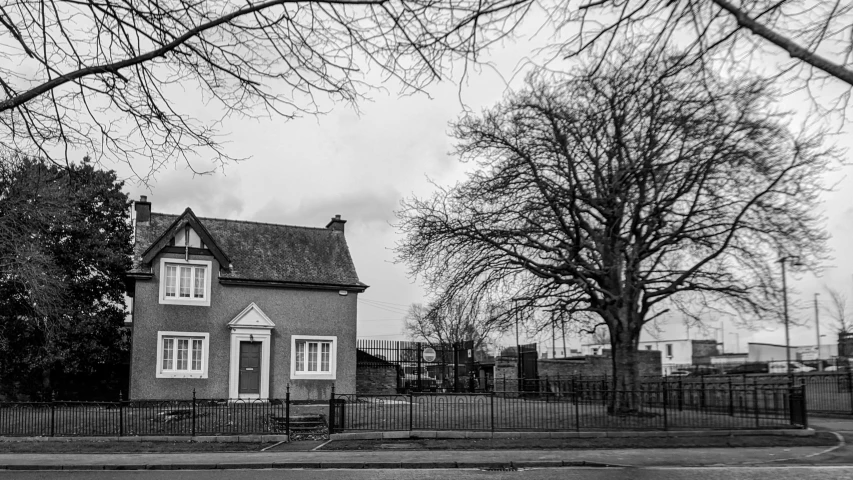 a house that is sitting next to some trees