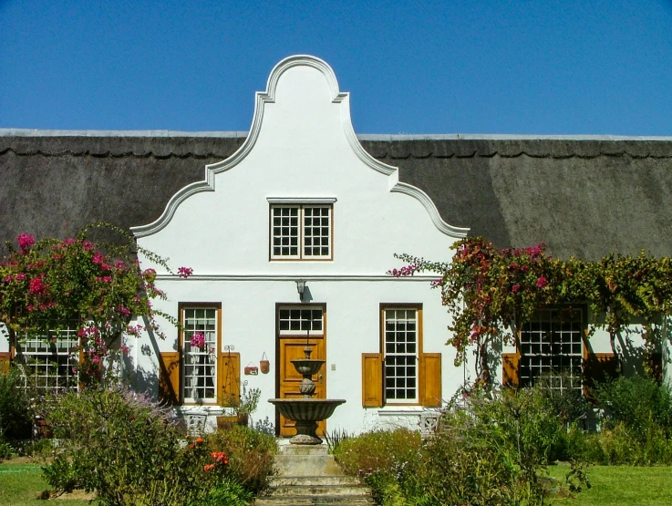 this is a very nice house with pretty flowers in front