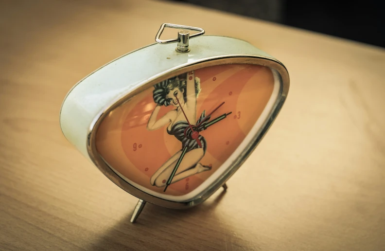 an alarm clock with a woman drawn on it's face
